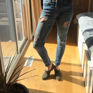 Distressed mid-rise denim.